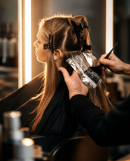 Professional hair styling with round brush and blow dryer at Ardan salon in Wellesley